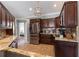 Updated kitchen with granite countertops, stainless steel appliances, and dark wood cabinets at 5437 Compass Pt # 00, Oxford, FL 34484