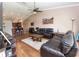 Cozy living room featuring hardwood floors, a ceiling fan, and comfortable leather sofas at 5437 Compass Pt # 00, Oxford, FL 34484