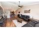 Inviting living room with hardwood floors, a ceiling fan, and an open layout connecting to the kitchen at 5437 Compass Pt # 00, Oxford, FL 34484