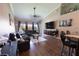 Bright living room with hardwood floors, high ceilings, and an open floor plan to the kitchen at 5437 Compass Pt # 00, Oxford, FL 34484