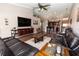 Spacious living room with hardwood floors, a ceiling fan, and an open floor plan leading to the kitchen at 5437 Compass Pt # 00, Oxford, FL 34484