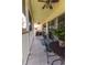 This long screened patio has cozy seating and a table for relaxing outdoors at 5437 Compass Pt # 00, Oxford, FL 34484