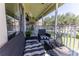 This charming screened patio has comfortable seating, a table, and a view of the lush surroundings at 5437 Compass Pt # 00, Oxford, FL 34484