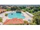 Aerial view showcasing a community pool with a waterfall, hot tub, and lounge chairs at 5437 Compass Pt # 00, Oxford, FL 34484