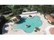 Aerial view of a large community pool featuring a waterfall, rock formations, and plenty of lounge chairs at 5437 Compass Pt # 00, Oxford, FL 34484