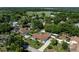 Beautiful aerial view of a single story home with mature landscaping, a long driveway and fully fenced yard at 5521 Oak St, Mount Dora, FL 32757