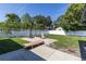 Spacious backyard with a basketball hoop, seating and a white fence at 5521 Oak St, Mount Dora, FL 32757