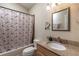 Cozy bathroom featuring granite counters, mirror, and a shower with patterned curtain at 5521 Oak St, Mount Dora, FL 32757