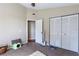 This bedroom features neutral walls, carpet flooring, and double door closets at 5521 Oak St, Mount Dora, FL 32757