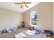 Bright bedroom with a ceiling fan, window, and neutral carpet at 5521 Oak St, Mount Dora, FL 32757