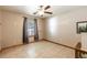 A charming bedroom with neutral colors, tile floors, ceiling fan and a wall decal at 5521 Oak St, Mount Dora, FL 32757