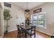 Well-lit dining room with a modern chandelier and a large window overlooking the yard at 5521 Oak St, Mount Dora, FL 32757