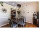 Open-concept dining area features wood floors, modern lighting, and easy access to the kitchen at 5521 Oak St, Mount Dora, FL 32757