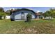 Exterior view of a single-story home with blue siding and manicured landscaping in a neighborhood setting at 5521 Oak St, Mount Dora, FL 32757