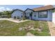 Beautiful home with front yard featuring rock landscaping, grass, and a paved walkway at 5521 Oak St, Mount Dora, FL 32757