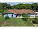 Captivating aerial view of a light blue single-Gathering home with a brown roof at 5521 Oak St, Mount Dora, FL 32757