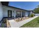 Inviting front porch with seating area, attractive landscaping, and a welcoming entrance at 5521 Oak St, Mount Dora, FL 32757