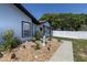 Front yard featuring rock landscaping, a walkway, and a beautifully maintained exterior at 5521 Oak St, Mount Dora, FL 32757