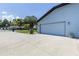 Attached two-car garage with large paved driveway and well-kept landscaping at 5521 Oak St, Mount Dora, FL 32757