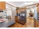 Modern kitchen with stainless steel refrigerator and adjacent dining area at 5521 Oak St, Mount Dora, FL 32757