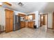 Well-lit kitchen showcasing oak cabinets, stainless steel appliances, and tile flooring at 5521 Oak St, Mount Dora, FL 32757