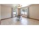Open floorplan with tile flooring, neutral walls, and ample natural light through large windows at 5521 Oak St, Mount Dora, FL 32757
