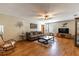 Inviting living room with a comfortable brown couch, ceiling fan, and wood-look flooring at 5521 Oak St, Mount Dora, FL 32757