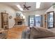 Inviting living room features a stone fireplace, skylights, ceiling fan, and sliding glass doors at 5521 Oak St, Mount Dora, FL 32757