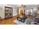 Open-concept living room featuring wood floors, a display cabinet, and neutral décor at 5521 Oak St, Mount Dora, FL 32757