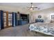 Spacious main bedroom with a ceiling fan, tv, and French door access to the lanai at 5521 Oak St, Mount Dora, FL 32757