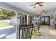 Spacious sunroom with multiple ceiling fans, tile flooring and access to an outdoor patio at 5521 Oak St, Mount Dora, FL 32757