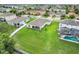 This aerial view shows the home with its spacious backyard and neighboring properties and community at 641 Black Eagle Dr, Groveland, FL 34736