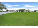 This home features a well-manicured lawn and an outdoor covered patio with views of the neighborhood at 641 Black Eagle Dr, Groveland, FL 34736