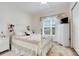 Cozy bedroom with a floral quilt bedspread, dresser, and large window that provides lots of natural light at 641 Black Eagle Dr, Groveland, FL 34736