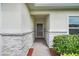 Close-up of a home's front entrance featuring stone accents, a covered porch, and inviting landscaping at 641 Black Eagle Dr, Groveland, FL 34736