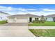 Charming single-story home with a three car garage, well-maintained landscaping, and a brick driveway at 641 Black Eagle Dr, Groveland, FL 34736