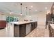 Well-equipped kitchen featuring stainless steel appliances, an island, and tile flooring at 641 Black Eagle Dr, Groveland, FL 34736