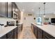 Eat-in kitchen boasting stainless steel appliances, stone countertops and dark wood cabinetry at 641 Black Eagle Dr, Groveland, FL 34736