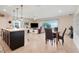 Open-concept living area with tile floors, ceiling fan, and sliding doors to the backyard at 641 Black Eagle Dr, Groveland, FL 34736
