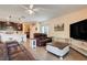 View of the living room featuring tile floors, a sectional sofa, and an entertainment center at 641 Black Eagle Dr, Groveland, FL 34736