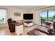 Comfortable living room features a flatscreen television and sliding glass doors to the patio at 641 Black Eagle Dr, Groveland, FL 34736