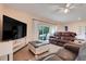 The inviting living area features an entertainment center and sliding glass doors to the patio at 641 Black Eagle Dr, Groveland, FL 34736