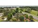 Aerial view of the property amidst lush greenery, showing proximity to road and lake at 707 S Dixie Dr, Howey In The Hills, FL 34737