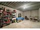 Spacious unfinished basement area perfect for storage or customization with concrete walls and shelving at 707 S Dixie Dr, Howey In The Hills, FL 34737