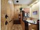 Luxurious bathroom featuring dual shower heads, a jacuzzi tub, and travertine tile at 707 S Dixie Dr, Howey In The Hills, FL 34737