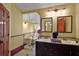 Bathroom with a classic design that includes a vintage tub, dual sinks, and patterned tile floor at 707 S Dixie Dr, Howey In The Hills, FL 34737