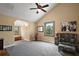 Bright bedroom with vaulted ceiling, carpet, and large windows providing natural light and comfortable setting at 707 S Dixie Dr, Howey In The Hills, FL 34737