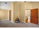 Open doorway in bedroom featuring neutral walls, carpet, and small table near to the entrance at 707 S Dixie Dr, Howey In The Hills, FL 34737
