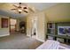 Carpeted bedroom with dormer windows, features a walk-in closet and ensuite bathroom at 707 S Dixie Dr, Howey In The Hills, FL 34737