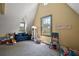 Bright playroom with vaulted ceiling, toys, and large windows providing natural light at 707 S Dixie Dr, Howey In The Hills, FL 34737